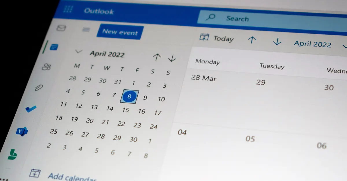 Macro shot of an Outlook calendar showing travel dates and OTA booking entries integrated into a daily schedule.