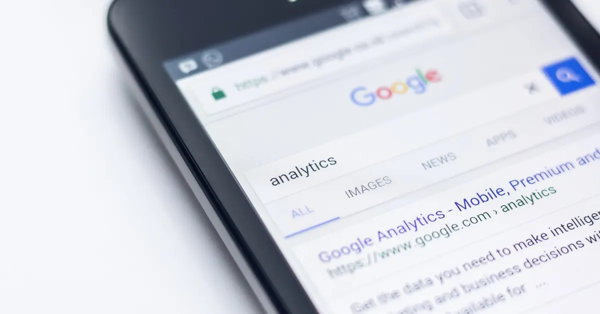 Close-up of a smartphone screen showing a Google search for "analytics" with search results for Google Analytics.